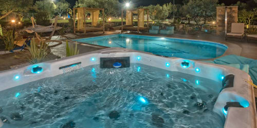 Illuminated hot tub and swimming pool at night, Villa Freedom boutique hotel in Kokkino Chorio, Crete