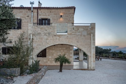 Villa Freedom stone entrance at dusk, Kokkino Chorio Crete with arched passageway and Mediterranean architecture