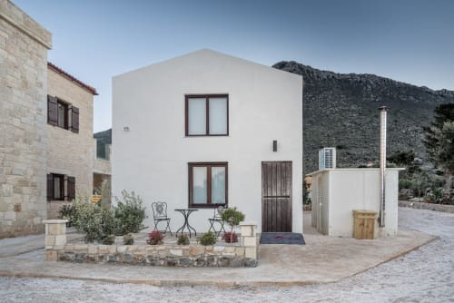 Villa Freedom B&B exterior in Kokkino Chorio, Crete with white facade, courtyard seating, and mountain views