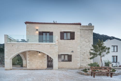 Villa Freedom stone guesthouse with arched entrance in Kokkino Chorio, Crete, at dusk