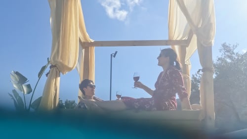 Couple enjoying wine at Villa Freedom pergola in Kokkino Chorio, Crete with sea views