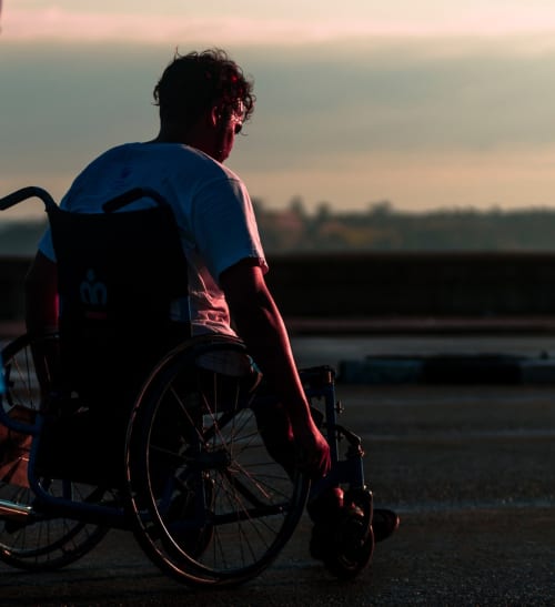 Man in wheelchair enjoying sunset view at Villa Freedom, accessible accommodation in Kokkino Chorio, Crete