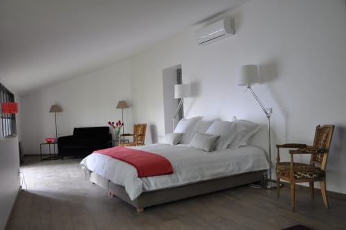 Spacious junior suite at Le Jardin De Beauvoir, Lyon BnB with queen bed, modern lamps, armchair and garden view