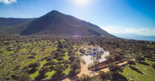 Villa Freedom BnB with volcanic mountain backdrop in Kokkino Chorio, Crete, surrounded by olive groves