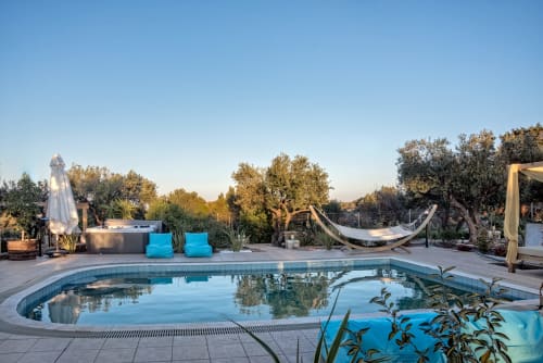 Villa Freedom pool in Kokkino Chorio, Crete - resort with lounge chairs, hammock, and Mediterranean garden