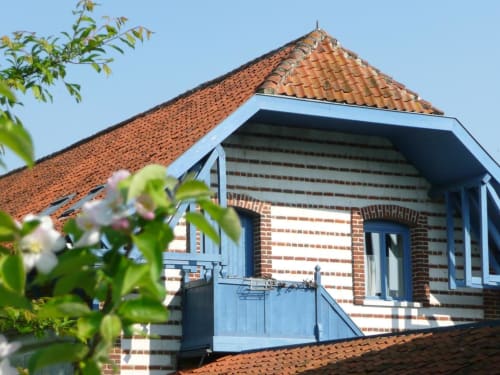 Au Petit Tambour D'Autingues BnB exterior with brick facade, blue shutters and terracotta roof in Autingues, France