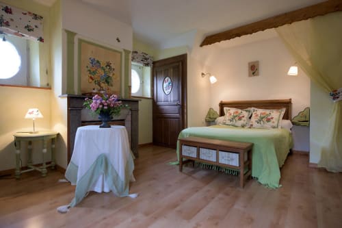 Flandre Room at Au Petit Tambour D'Autingues, cozy bedroom with green accents, floral details, fireplace, and wooden