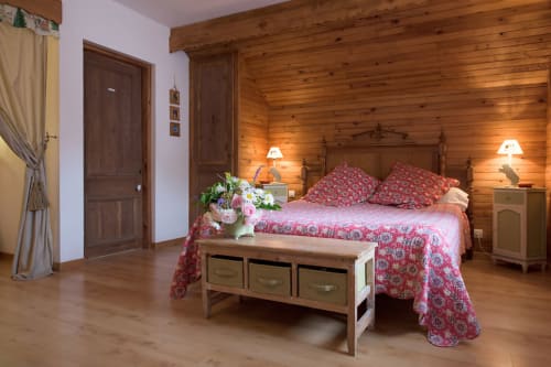 Edelweiss Room at Au Petit Tambour D'Autingues B&B in Autingues, France with wooden beams, red patterned bedding, and garden