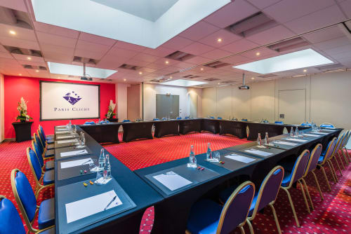 Modern conference room at Hotel Residence Europe & Spa in Clichy with U-shaped seating, red carpet, and Paris Clichy branding