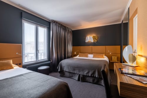 Triple room at Hotel Residence Europe & Spa in Clichy with two beds, orange headboards, and modern black and gold décor
