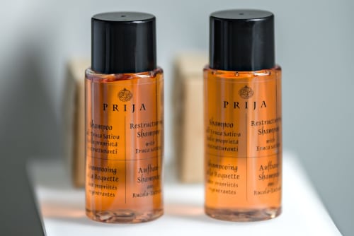 Two PRIJA restructuring shampoo bottles in Comfort Room at Hotel Residence Europe & Spa, Clichy