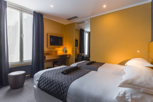 Bright yellow Comfort Room at Hotel Residence Europe & Spa in Clichy with twin beds, desk, TV and modern furnishings