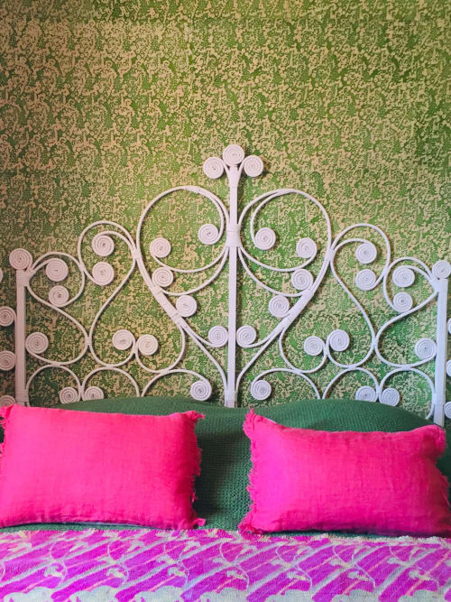 Ornate white headboard with pink pillows at Saint Martin B&B in Ollioules, France