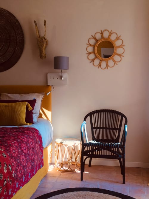 Colorful bedroom at Saint Martin B&B in Ollioules with wicker décor, floral bedding, and rattan chair