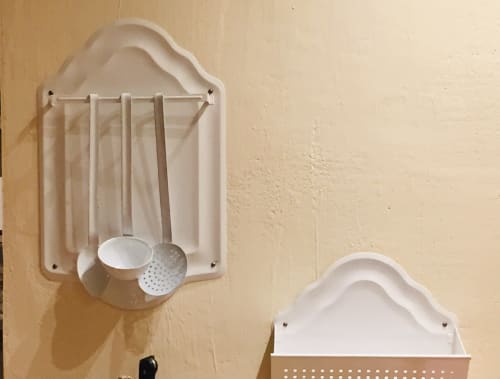 White wall-mounted kitchen organizer with utensils at Saint Martin B&B in Ollioules, France