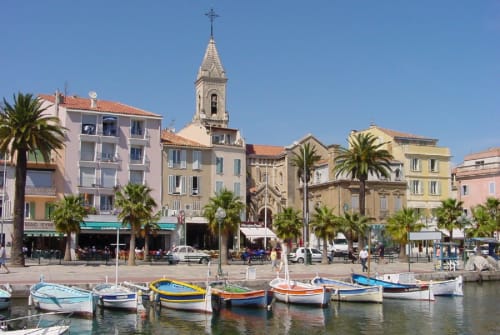 Colorful boats in Mediterranean harbor at Saint Martin B&B, Ollioules France with church spire