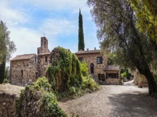 Saint Martin B&B in Ollioules, France: rustic stone buildings with cypress trees and ivy-covered walls