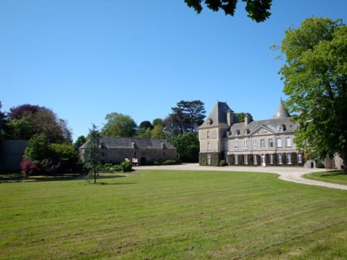 Château d'Alexis de Tocqueville mansion with manicured lawn, turrets, and French gardens in Tocqueville