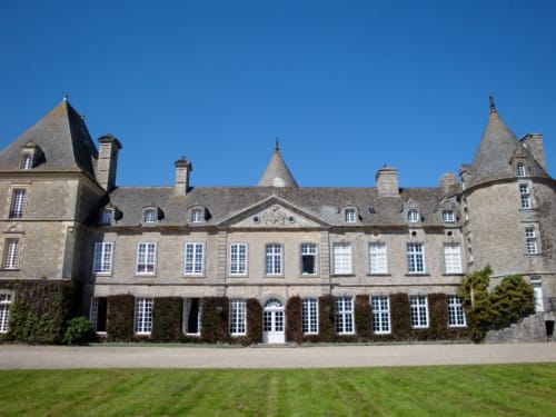 Château d'Alexis de Tocqueville, a stone manor house with turrets and mansard roofs in Tocqueville, France