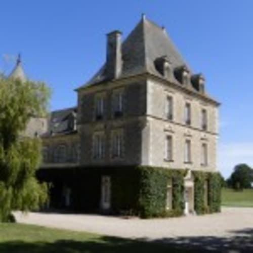 Château d'Alexis de Tocqueville, a historic stone manor with mansard roof in Tocqueville, France