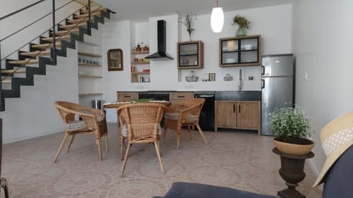 Modern cottage kitchen and dining area at Mas des Artistes in Mouriès with wicker chairs, stainless steel appliances, and