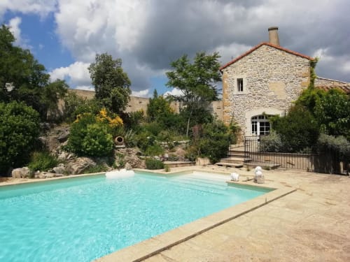 Turquoise pool at Mas des Artistes, stone Provençal house with gardens in Mouriès, France