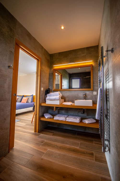 Salle de bains moderne à La Villa Miami, La Maison D'ambrine : vanité en bois, miroir lumineux et accès à la chambre
