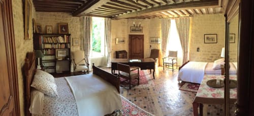 Chambre de la tour au Château d'Asnières en Bessin avec lit, bureau, fenêtres sur jardin et décor classique français