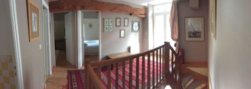 Upstairs hallway at Chateau d'Asnieres en Bessin cottage with wooden railings, bedroom entrance, and garden views