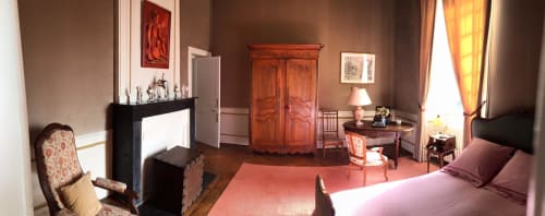 Elegant bedroom at Chateau d'Asnieres en Bessin with period furnishings, fireplace, and garden view in Asnières en Bessin,