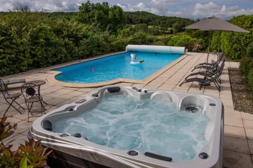 Luxury hot tub and swimming pool at Belloréade B&B in Belloc with garden views