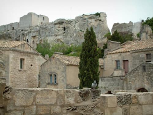Mas des Artistes stone buildings with cypress trees and ruined fortress, Mouriès Provence