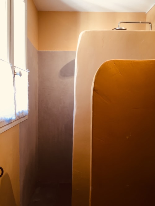 Shower stall in modern bathroom at Saint Martin B&B, Ollioules France with orange tile walls