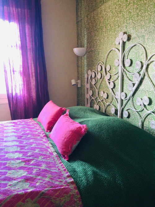 Colorful bedroom at Saint Martin B&B Ollioules with pink pillows, green headboard, and purple curtains