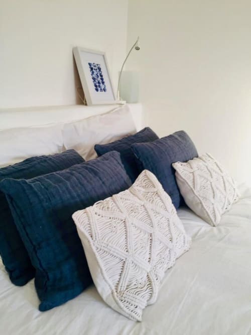 Cozy bed at Saint Martin B&B in Ollioules with layered pillows and dark quilts