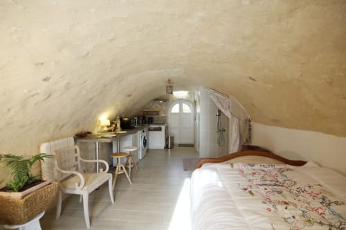 Gîte Studio Tana aux Gîtes des châteaux avec plafond voûté, lit, kitchenette et douche à Vallières-les-Grandes