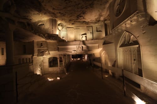 Underground stone passage with arched doorways at Les gîtes des châteaux, Vallières-les-Grandes, France