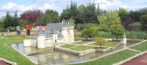 Miniature castle with moat at Les gîtes des châteaux BnB in Vallières-les-Grandes, France