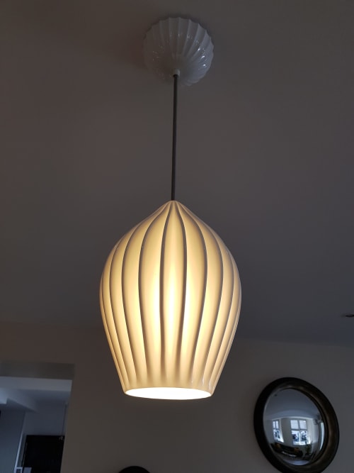 Pendant lamp with ribbed cream-colored shade hanging in Hotel Au Bon Coin, Biarritz