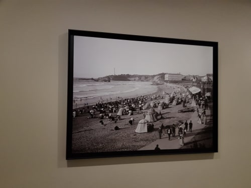 Vintage black and white photograph of Biarritz beach crowded with beachgoers and striped umbrellas, with Hotel Au Bon Coin
