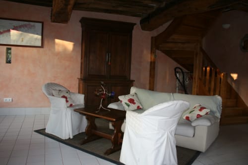 Elegant living room in La Bouverie cottage at La Chatellerie B&B, Saint Aubin le Cauf, with white-draped seating and