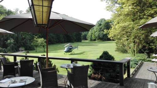 Château d'Hassonville terrace with helicopter landing on manicured lawn, Marche-en-Famenne