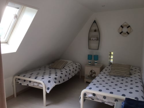 Twin bedroom in La Bouverie cottage at La Chatellenie, Saint Aubin le Cauf, with polka dot bedding and skylights