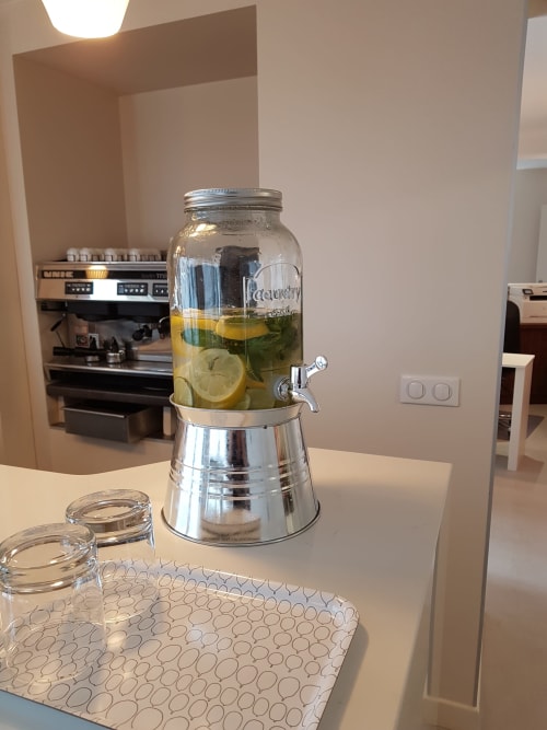 Modern kitchen counter at Hotel Au Bon Coin Biarritz with infused water dispenser and glassware