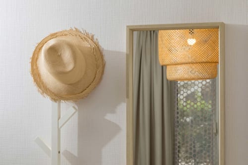 Chapeau de paille au mur avec lampe tressée et rideaux dans le studio Un Air De Famille, Vittel