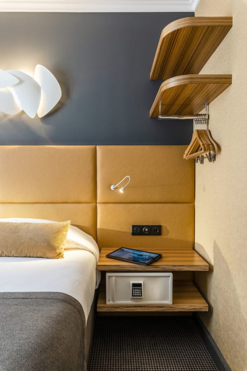Classic Room at Hotel Residence Europe & Spa in Clichy featuring modern bedside table with wooden shelves, yellow upholstered