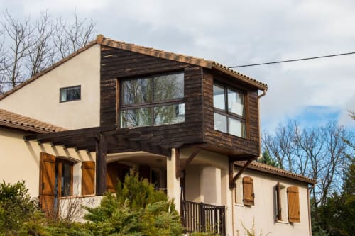 Belloréade B&B in Belloc features modern dark wood upper level with large windows overlooking bare trees and countryside