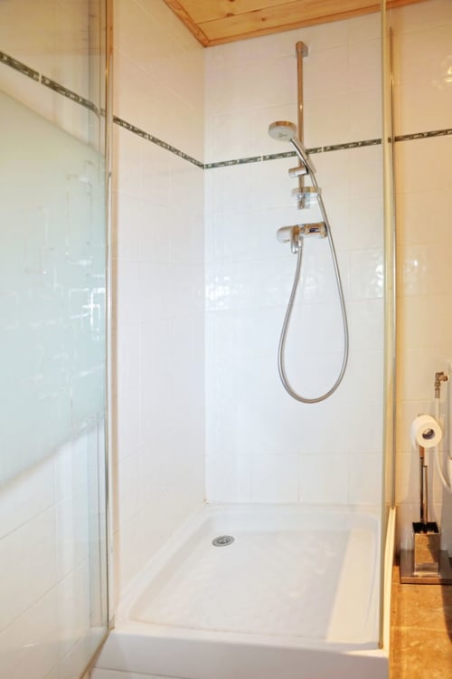 Modern walk-in shower with glass enclosure in Petit Loup room at Chalet La Louvière, La Toussuire