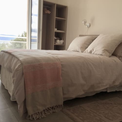 Modern bedroom at Villas Marincelu with neutral bedding, sea view window, and built-in shelving in Serra di Ferro