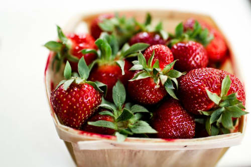 Fresh red strawberries in wooden crate at Villas Marincelu hotel, Corsica